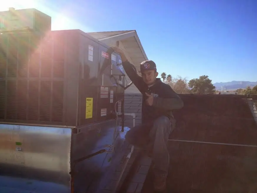 HVAC technician performing AC Tune-Up on a rooftop unit in Cascade
